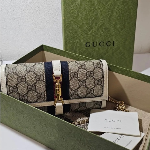 Gucci Handbags - Gucci Beige and Black Clutch with Gold Accents